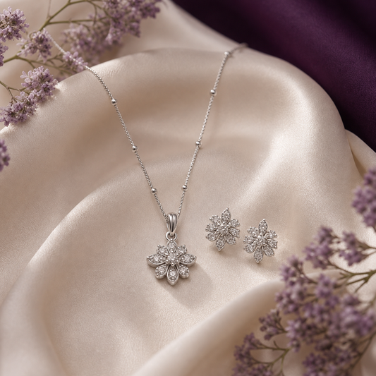 Floral silver pendant set with earrings on ivory silk